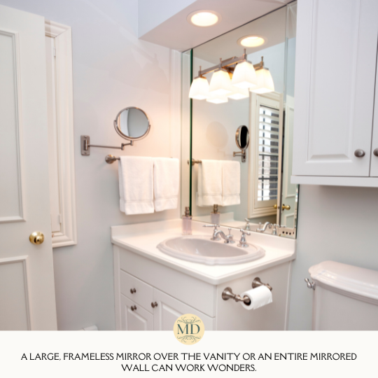 A large, frameless mirror over the vanity or an entire mirrored wall can work wonders.