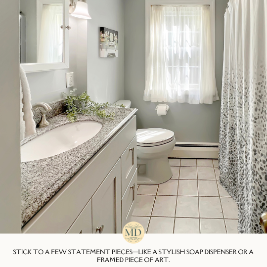 Stick to a few statement pieces—like a stylish soap dispenser or a framed piece of art—rather than cluttering the space with too many accessories.