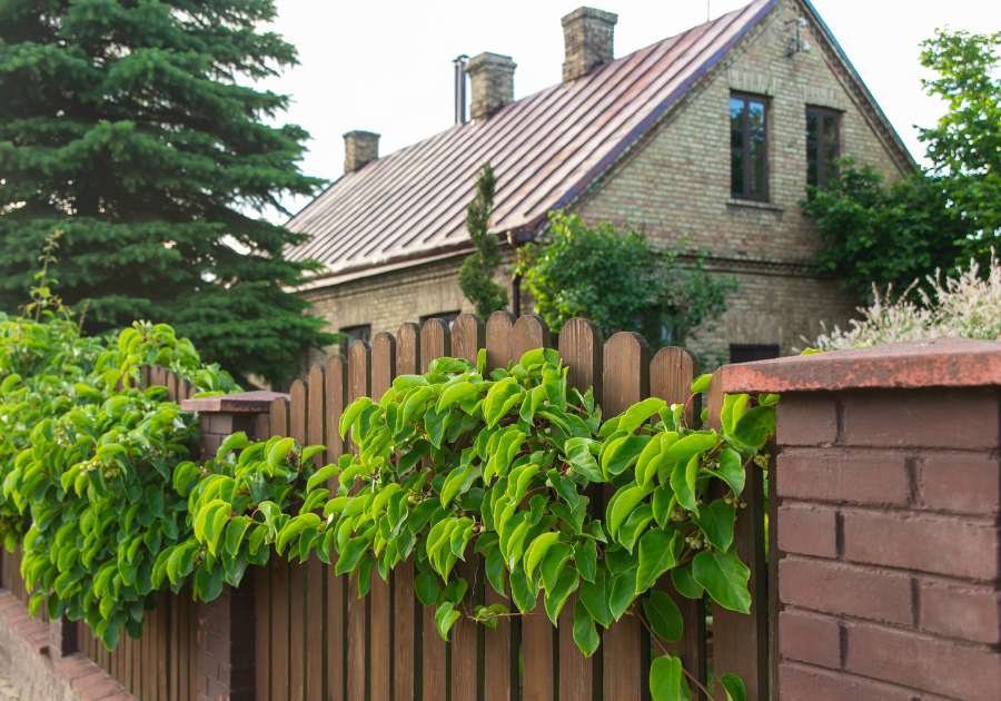 historic central Massachusetts home with fence in summer