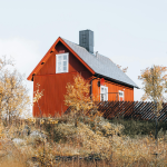 Red Cabin in an open field in fall