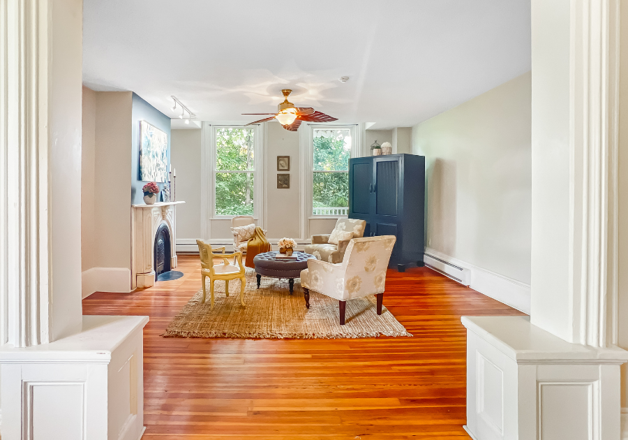 historic living room with hardwood floor and original fireplace with millwork
