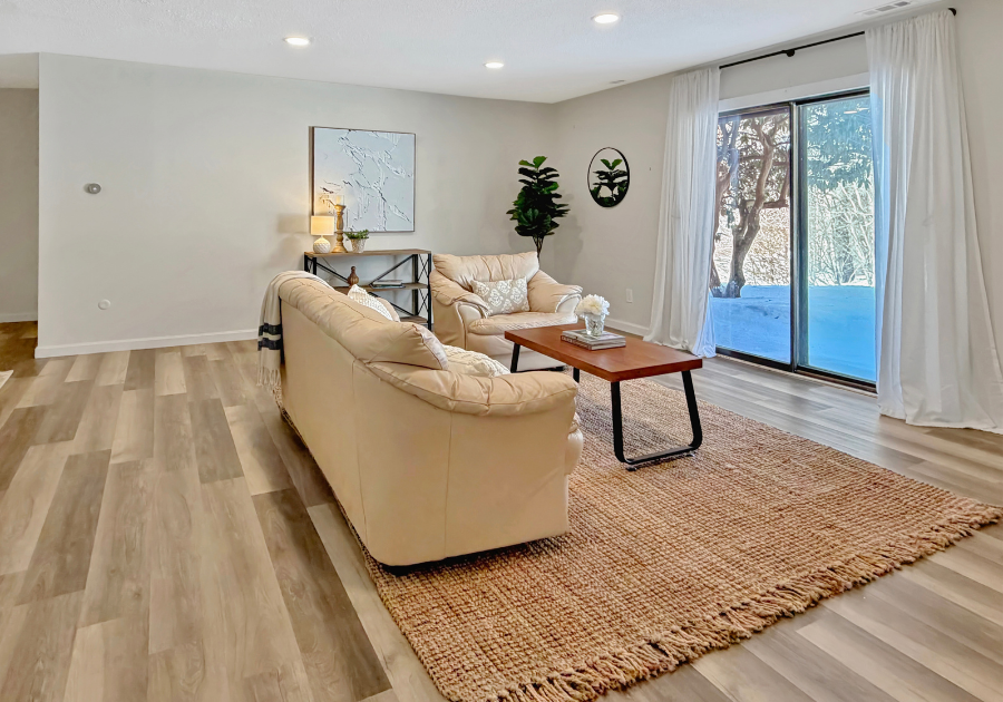 styled bright living room with curtains open to winter scene