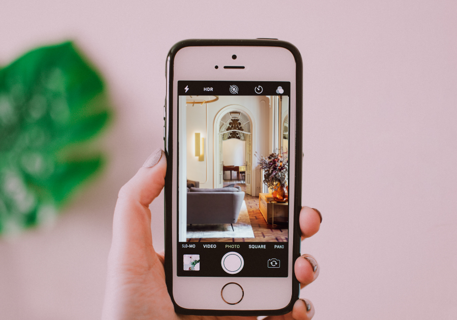 person taking a photo of room holding in doorway before photo day 